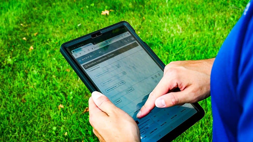 Inspector-with-Tablet---Exterior-1 - Water Meter Replacement | Water Meter Testing - HydroCorp